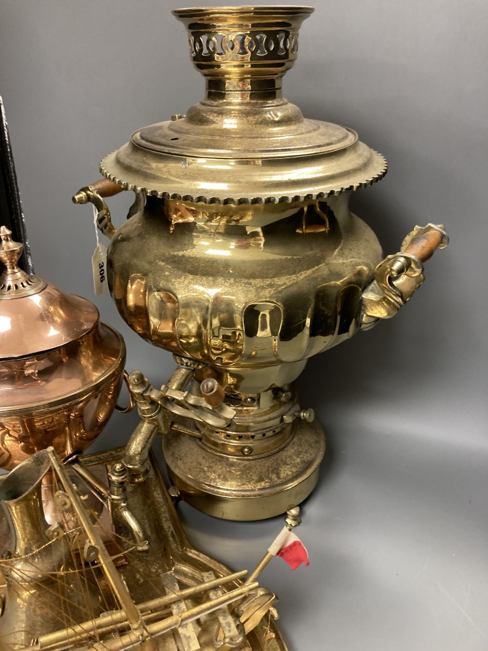 A Russian brass samovar and stand, height 47cm, a copper tea urn, a brass jug and a pair of champleve mugs